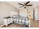 Comfortable bedroom with a ceiling fan, a well-made bed, and an en suite at 10246 Tall Oaks Cir, Parker, CO 80134