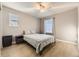 Bright bedroom with a ceiling fan, light wood floors, and natural light from two windows at 10246 Tall Oaks Cir, Parker, CO 80134