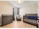 Neutral Bedroom features crib, dresser, and rocking chair at 10246 Tall Oaks Cir, Parker, CO 80134