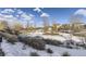 A community view with several homes, bare trees, and snow-covered ground at 10246 Tall Oaks Cir, Parker, CO 80134