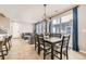 Open dining area with a large table, light-colored floors, and modern chandelier at 10246 Tall Oaks Cir, Parker, CO 80134