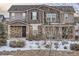 Two-story house with stone accents and a covered porch, snow-covered landscaping at 10246 Tall Oaks Cir, Parker, CO 80134