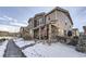 Exterior shot of homes featuring covered porches and stone accents at 10246 Tall Oaks Cir, Parker, CO 80134