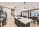 Open concept kitchen with island, stainless steel appliances, and light colored floors at 10246 Tall Oaks Cir, Parker, CO 80134