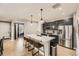 Modern kitchen with an island, stainless steel appliances, and light countertops at 10246 Tall Oaks Cir, Parker, CO 80134