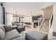 Spacious living room with gray sectional sofa, ottoman, and large windows at 10246 Tall Oaks Cir, Parker, CO 80134