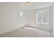 Well-lit bedroom with two windows, neutral carpet, and white walls at 28644 E 7Th Ave, Watkins, CO 80137