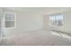 Bright bedroom featuring neutral carpet, white walls, and large windows at 28644 E 7Th Ave, Watkins, CO 80137