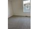 Empty bedroom features neutral carpeting, light walls, a window, and a heating vent at 28644 E 7Th Ave, Watkins, CO 80137