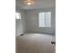 Carpeted bedroom with white walls and two windows offering natural light at 28644 E 7Th Ave, Watkins, CO 80137