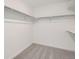 Walk-in closet with ample shelving and neutral carpeting at 28644 E 7Th Ave, Watkins, CO 80137