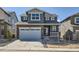 Two-story home featuring a stone facade and a two-car garage at 28644 E 7Th Ave, Watkins, CO 80137