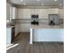 Bright kitchen with white cabinets, stainless steel appliances, and stone countertops at 28644 E 7Th Ave, Watkins, CO 80137