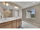 Bathroom featuring a dual sink vanity and a walk-in shower with glass doors at 7465 E 157Th Pl, Thornton, CO 80602