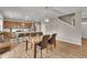 Open dining area with hardwood floors adjacent to a modern kitchen and stairs at 7465 E 157Th Pl, Thornton, CO 80602