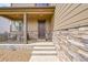 Inviting covered front porch and stone accents at 7465 E 157Th Pl, Thornton, CO 80602