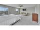 Large main bedroom with a sitting area, TV, large windows with neighborhood views, and neutral decor at 7465 E 157Th Pl, Thornton, CO 80602