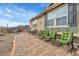 Charming backyard with brick patio, rocking chairs, and manicured lawn at 9868 Olathe St, Commerce City, CO 80022