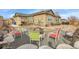 Charming backyard featuring a fire pit with chairs and an outdoor seating area at 9868 Olathe St, Commerce City, CO 80022