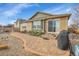 Well-maintained backyard features brick patio, outdoor seating, and a built-in grill at 9868 Olathe St, Commerce City, CO 80022