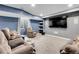 Finished basement area featuring plush seating and a large wall-mounted television at 9868 Olathe St, Commerce City, CO 80022