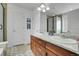 An ample bathroom with double sinks, granite countertops, and multiple storage spaces at 9868 Olathe St, Commerce City, CO 80022