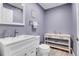 Stylish half-bath with modern vanity, mirror, and sleek fixtures at 9868 Olathe St, Commerce City, CO 80022