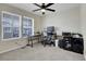 Well-lit home office featuring a ceiling fan and two windows providing natural light at 9868 Olathe St, Commerce City, CO 80022