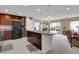 Open-concept kitchen with an island, stainless steel appliances, and adjacent dining area at 9868 Olathe St, Commerce City, CO 80022