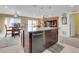 Kitchen island with a stainless steel dishwasher and view of dining area and Gathering room at 9868 Olathe St, Commerce City, CO 80022