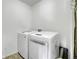 Bright laundry room with a modern washer and dryer and tiled floors at 9868 Olathe St, Commerce City, CO 80022