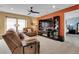 Comfortable living room with a fireplace, built-in shelving, and plenty of natural light at 9868 Olathe St, Commerce City, CO 80022