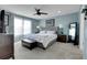 Comfortable main bedroom featuring a large bed, soft blue walls, and an abundance of natural light at 9868 Olathe St, Commerce City, CO 80022