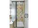 Tiled shower with a glass door and tiled walls featuring inset shelves at 9868 Olathe St, Commerce City, CO 80022