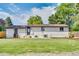 Large backyard featuring lush green lawn, brick house exterior, and mulch filled garden at 1226 W 98Th Ave, Northglenn, CO 80260