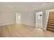 Spacious basement area with laminate flooring and access to a staircase at 1226 W 98Th Ave, Northglenn, CO 80260