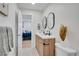 Modern bathroom features a double vanity, stylish mirrors, and contemporary finishes at 1226 W 98Th Ave, Northglenn, CO 80260