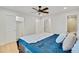 Bright bedroom with a ceiling fan, closet, ensuite bathroom, and blue bedspread at 1226 W 98Th Ave, Northglenn, CO 80260