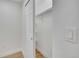 A well-organized, all-white closet with wooden floors, shelving, and a hanging rod at 1226 W 98Th Ave, Northglenn, CO 80260