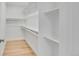 Spacious walk-in closet with ample shelving and hardwood floors at 1226 W 98Th Ave, Northglenn, CO 80260