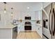 Modern kitchen featuring stainless steel appliances, white cabinetry, and light countertops at 1226 W 98Th Ave, Northglenn, CO 80260