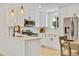 Bright kitchen with white cabinetry, stainless steel appliances, and stylish pendant lighting at 1226 W 98Th Ave, Northglenn, CO 80260
