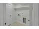 Clean laundry room featuring tiled floors, utility sink, and washer/dryer hookups at 1226 W 98Th Ave, Northglenn, CO 80260