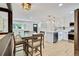 Light-filled living and dining area with modern light fixtures and hardwood floors at 1226 W 98Th Ave, Northglenn, CO 80260