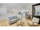 Cozy living room with hardwood floors, grey sofa, and open layout to the kitchen at 1226 W 98Th Ave, Northglenn, CO 80260