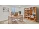 Home office featuring a desk, chair, bookcase, window, and carpeted floor at 1226 W 98Th Ave, Northglenn, CO 80260