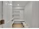 Walk-in pantry with ample white shelves and storage space; canned goods are stored here at 1226 W 98Th Ave, Northglenn, CO 80260