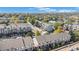 Aerial view of townhomes, trees, streets, parking, sidewalks, and buildings with fall colors at 2215 E 103Rd Pl, Thornton, CO 80229