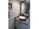 Stylish half bathroom featuring a vessel sink, modern hardware, and elegant decor at 2215 E 103Rd Pl, Thornton, CO 80229