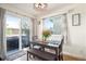 Bright dining area with sliding glass doors to the patio and a modern light fixture at 2215 E 103Rd Pl, Thornton, CO 80229